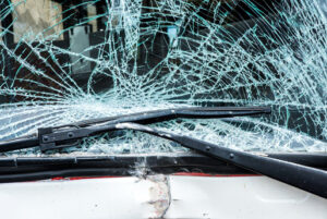 broken windshield of bus after car crash