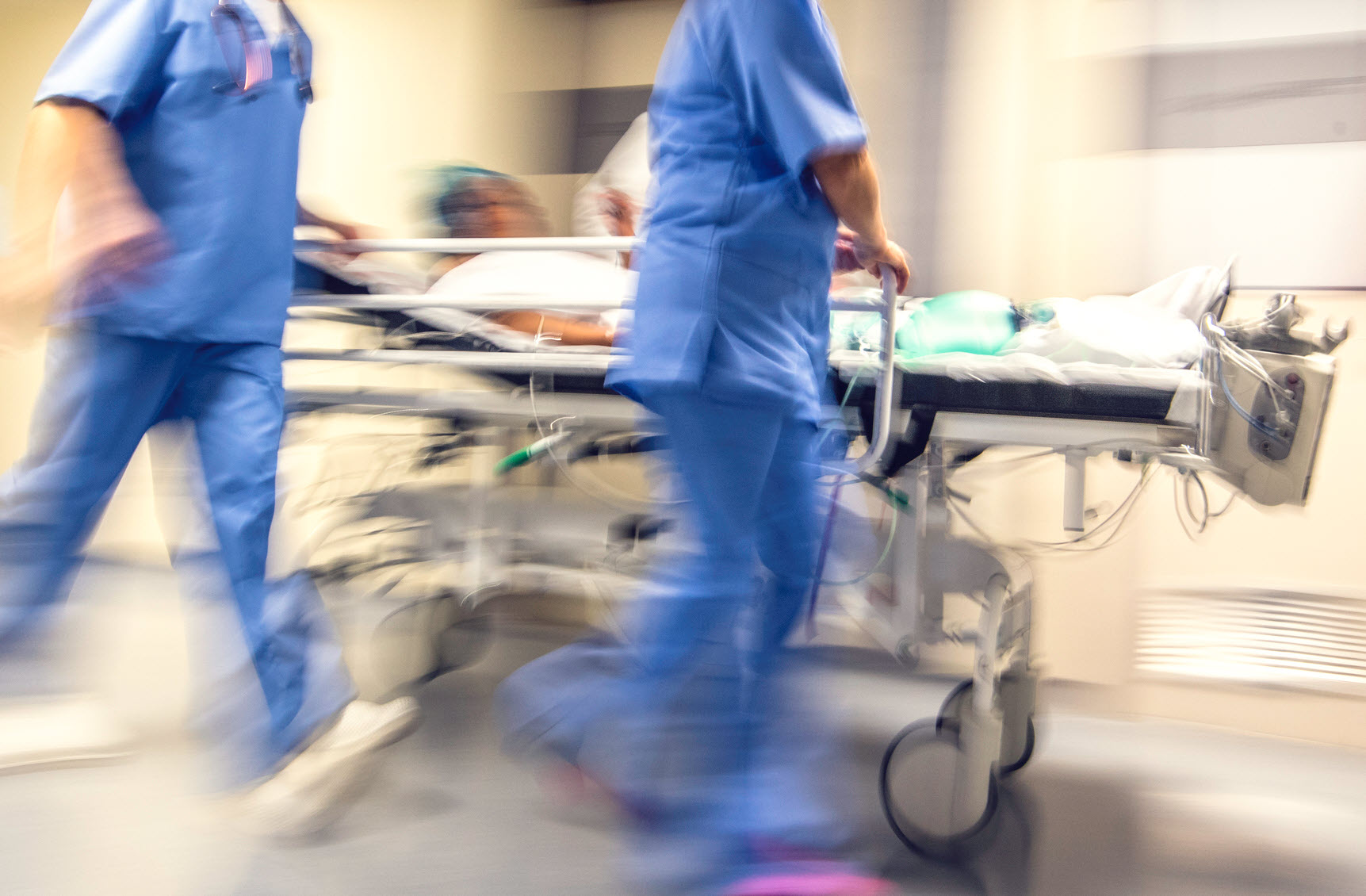 doctors rush patient on hospital bed to ICU